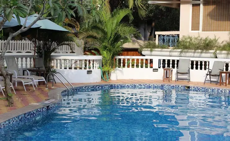 Poolside terrace with white balustrade and umbrellas by Heavenly Outdoor in Fulshear, TX