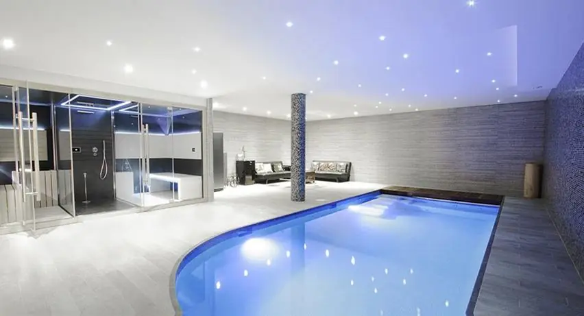 Raised spa spilling into a pool