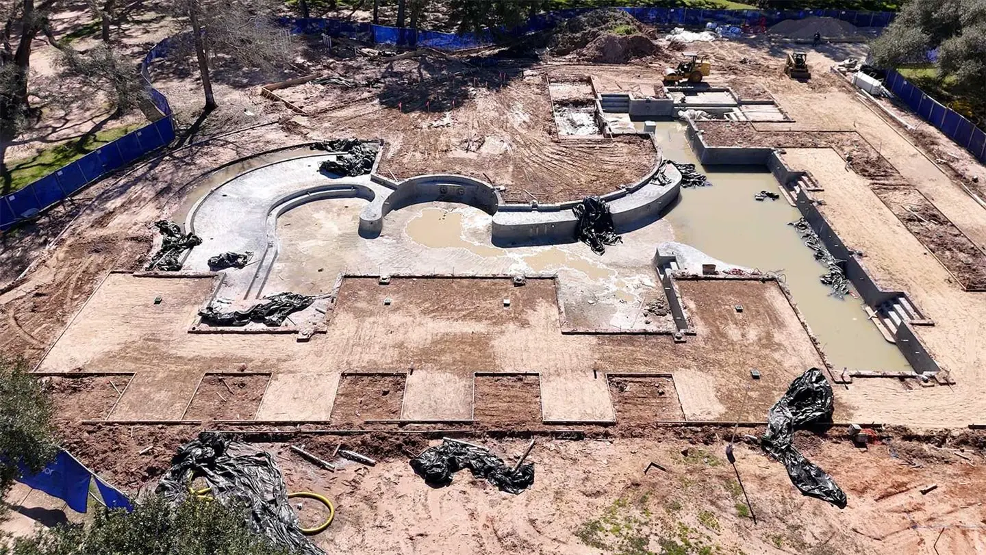 Aerial view of a pool under construction at The Clubs at Houston Oaks
