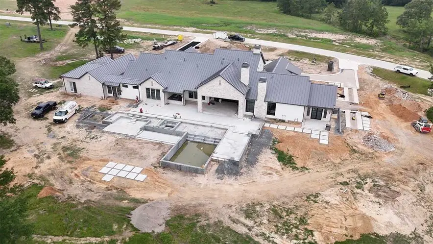 Aerial view of a large estate home site under construction